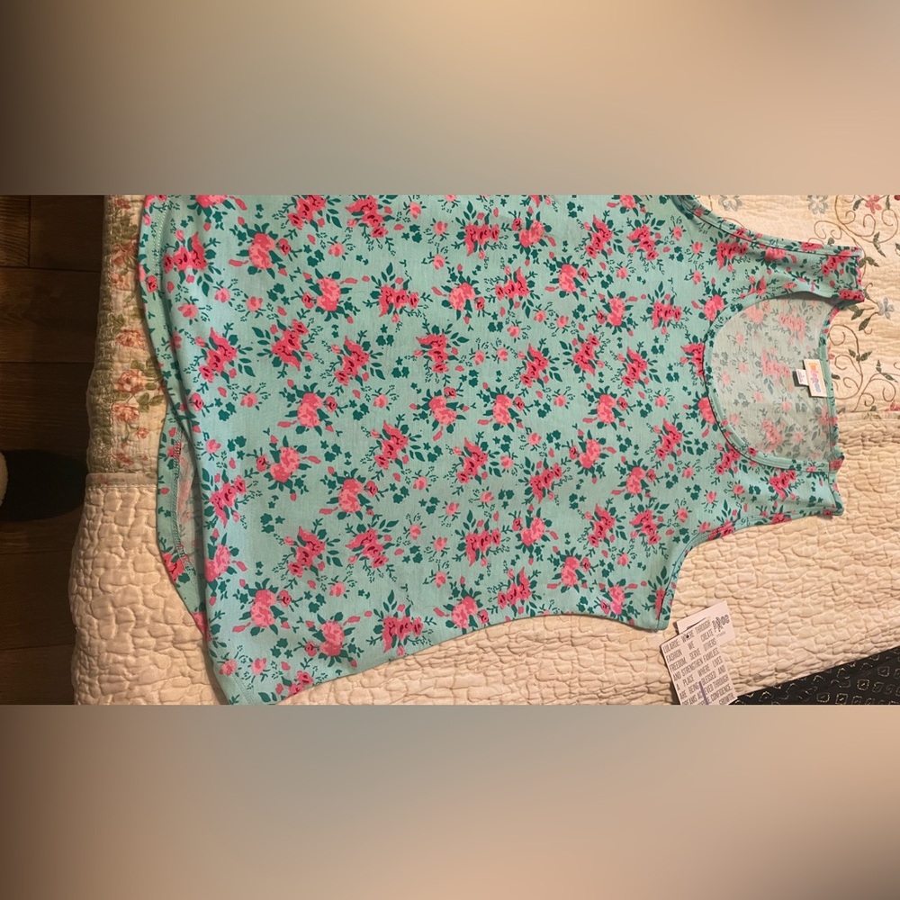 LuLaRoe tank top, aqua color with pink flowers. Fits more like a medium.